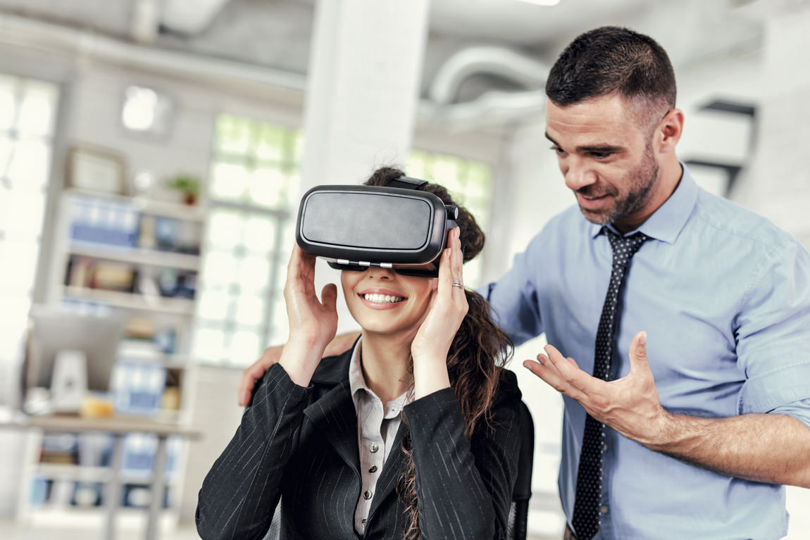 Sales manager demonstrates a client future apartment with VR headset