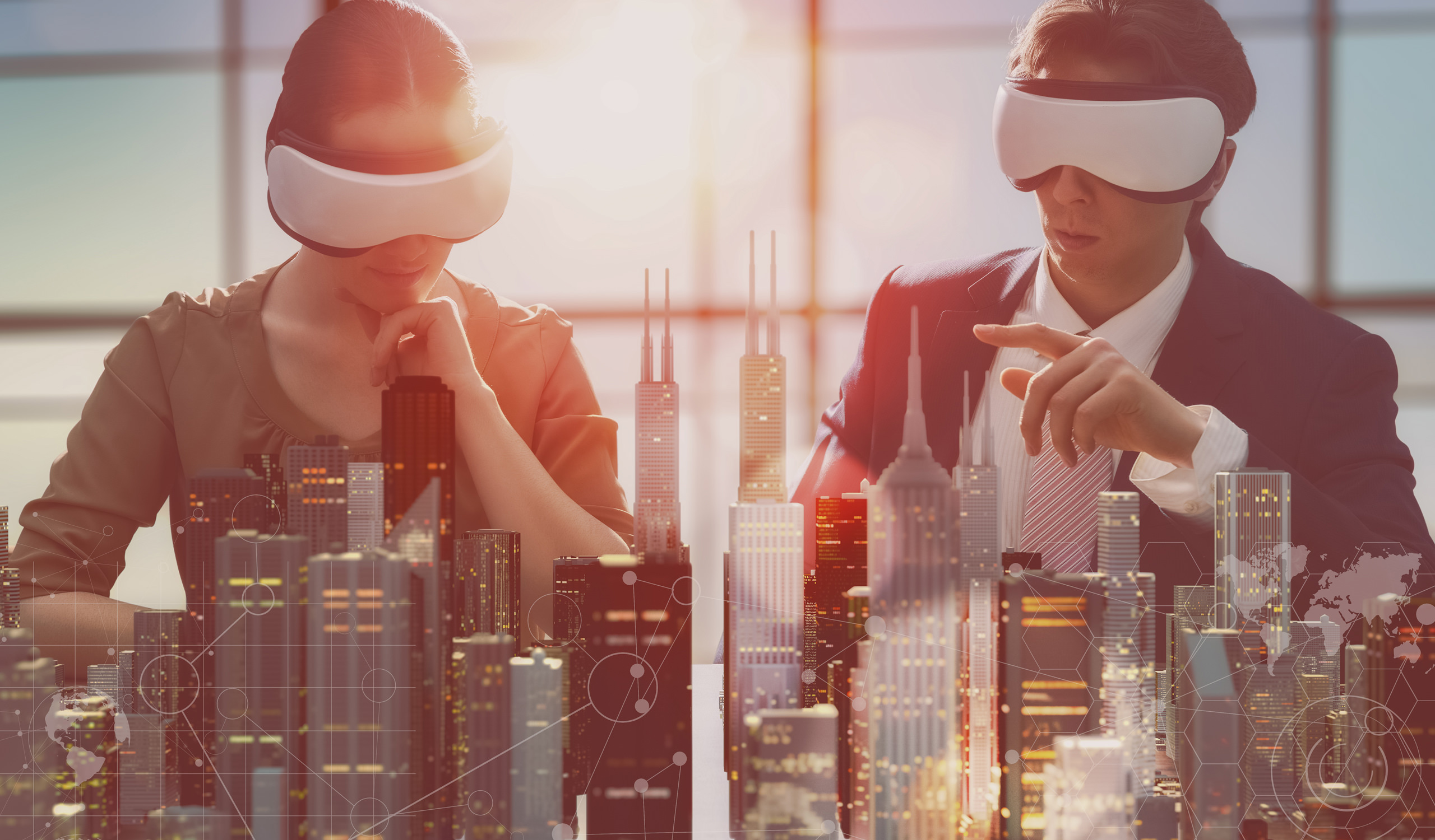 Lunas Visialization Studio creates interactive virtual reality tours for real property and developers markets. Man and woman watching city construction plan with VR glasses in the office