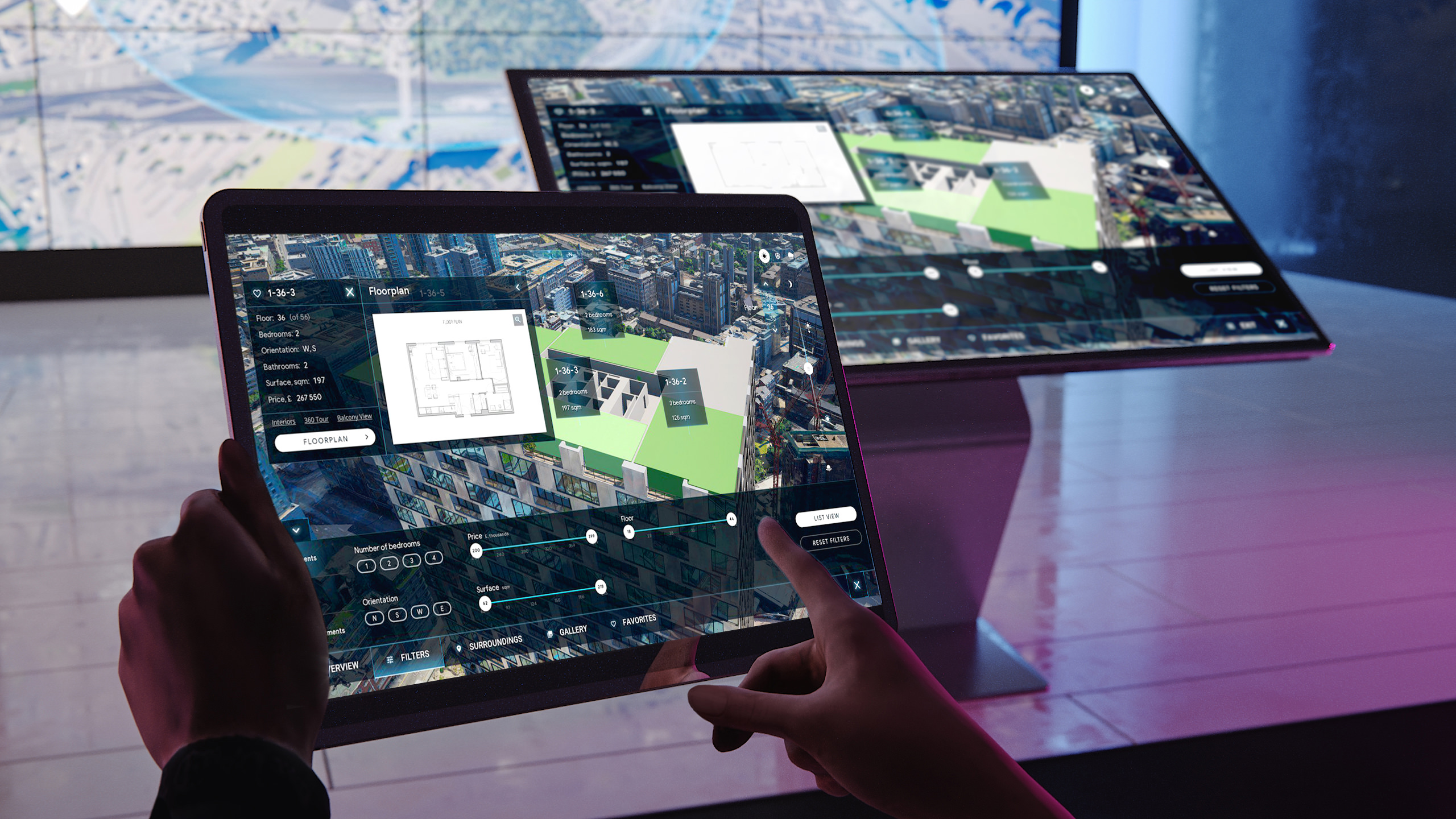 Man holding a tablet with visual data in his hands in front of a touch screen and a video-wall