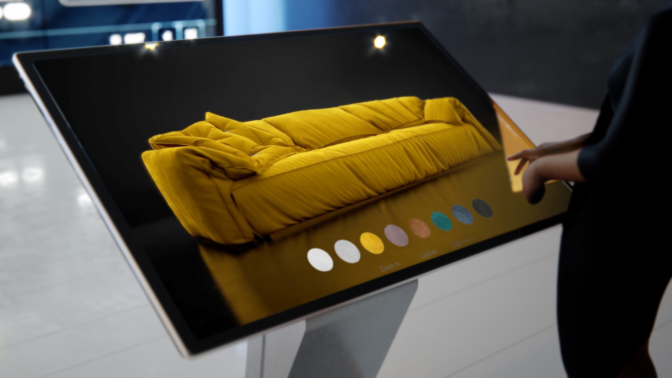 A modern interactive touchscreen displaying a yellow singe cushion sofa in the dark studio lighting and a toolbar that shows possible modes to apply for e-commerce business or online shop