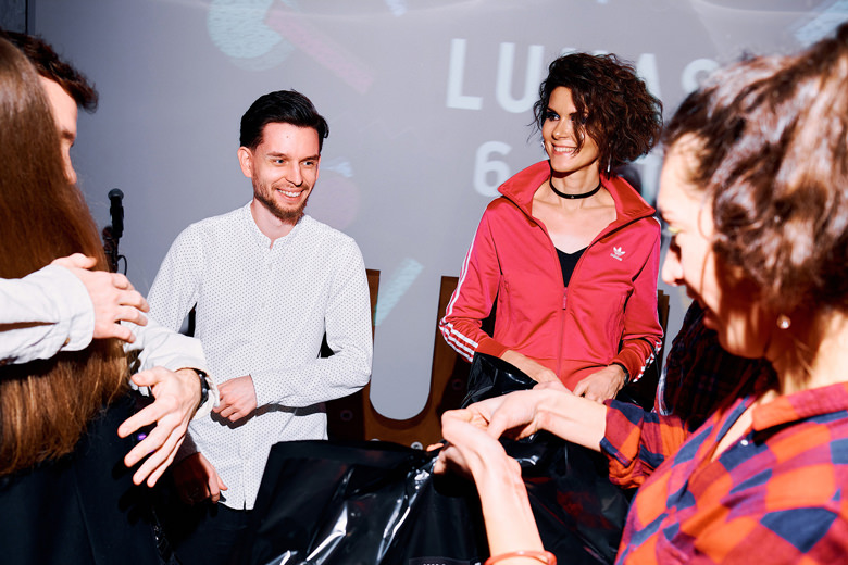 Maria Kladova and Vasiliy Guscha smiling at the birthday party during receiving the presents